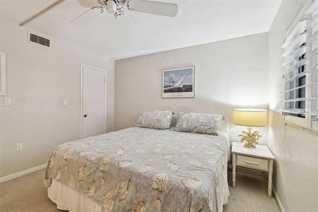200 1st Ave Unit 406, St Pete Beach, FL 33706 - carpeted bedroom with a textured ceiling, ceiling fan, and baseboards
