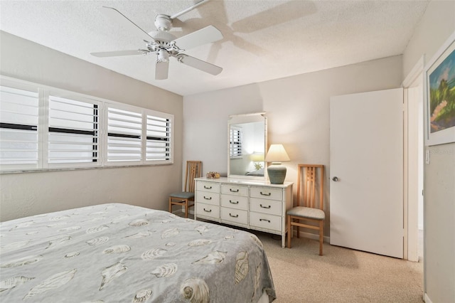 200 1st Ave Unit 406, St Pete Beach, FL 33706 - bedroom with light carpet, a textured ceiling, and a ceiling fan