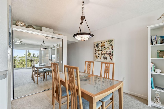 200 1st Ave Unit 406, St Pete Beach, FL 33706 - dining space featuring carpet and a ceiling fan