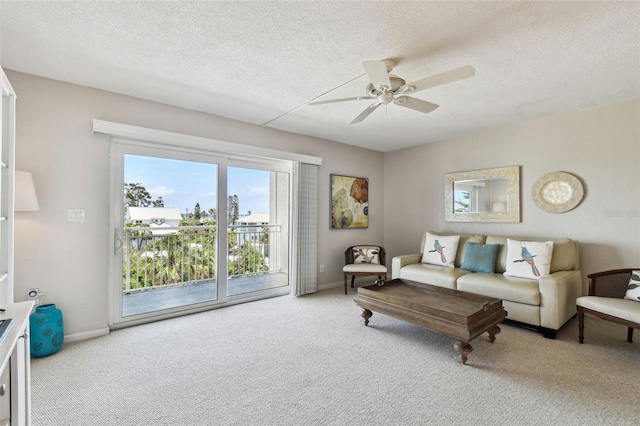 200 1st Ave Unit 406, St Pete Beach, FL 33706 - carpeted living area featuring ceiling fan, a textured ceiling, and baseboards