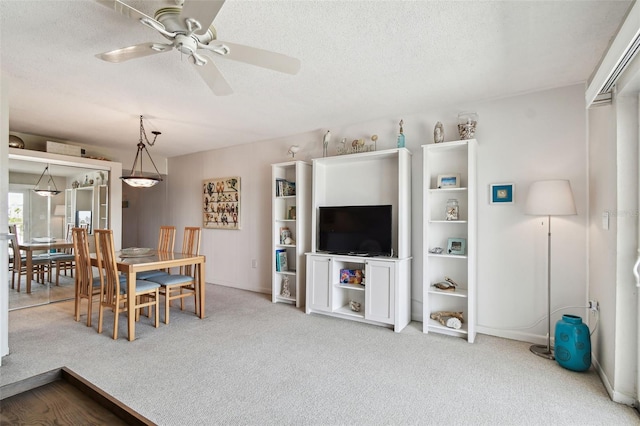 200 1st Ave Unit 406, St Pete Beach, FL 33706 - dining room with carpet floors, a ceiling fan, a textured ceiling, and baseboards