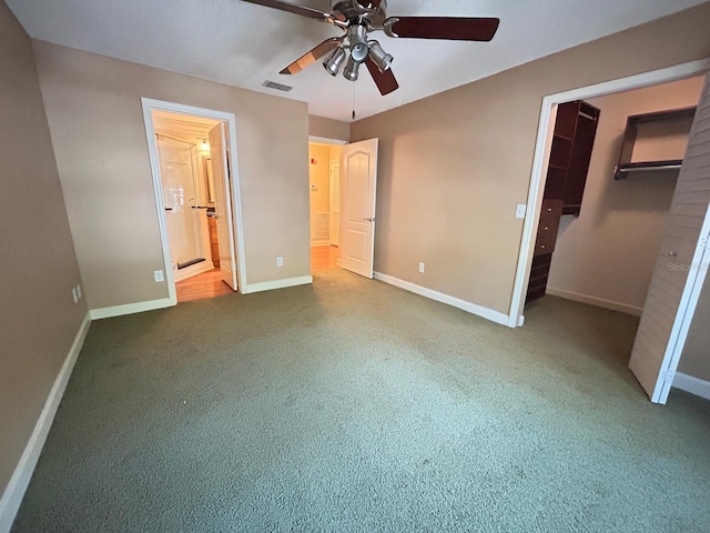 622 Seascape Way, Tampa, FL 33602 - unfurnished bedroom featuring a walk in closet, baseboards, carpet, and ensuite bath