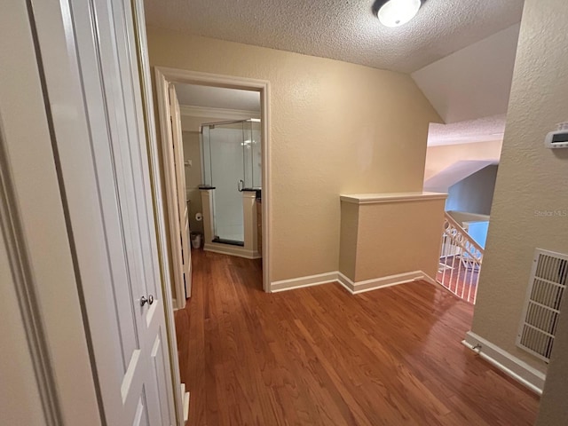 622 Seascape Way, Tampa, FL 33602 - hallway featuring a textured wall, an upstairs landing, a textured ceiling, wood finished floors, and baseboards
