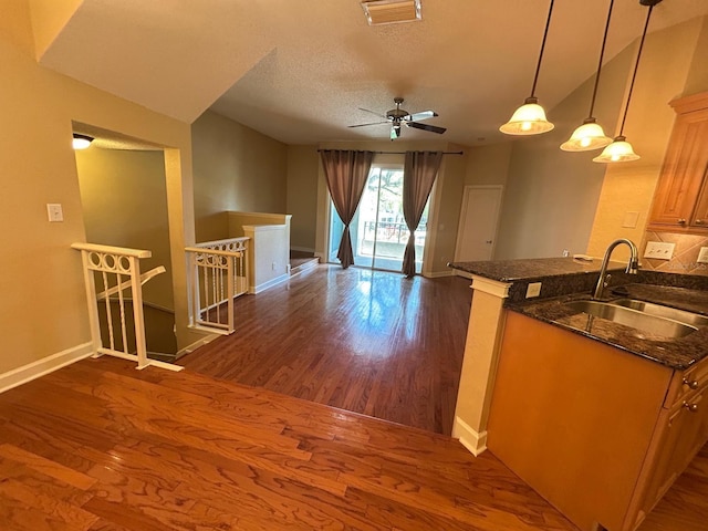 622 Seascape Way, Tampa, FL 33602 - kitchen with a sink, dark wood-style flooring, baseboards, ceiling fan, and a textured ceiling