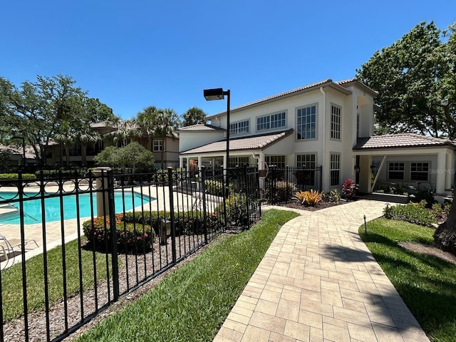 622 Seascape Way, Tampa, FL 33602 - rear view of house with fence, a tiled roof, and stucco siding