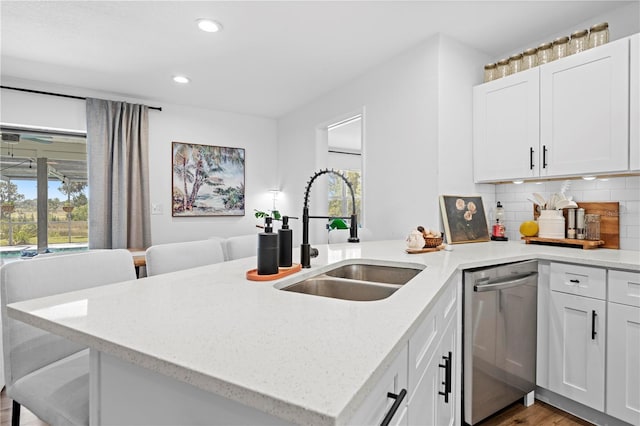 3041 Waterfall Dr, Spring Hill, FL 34608 - kitchen featuring a sink, dishwasher, recessed lighting, light stone countertops, and white cabinets