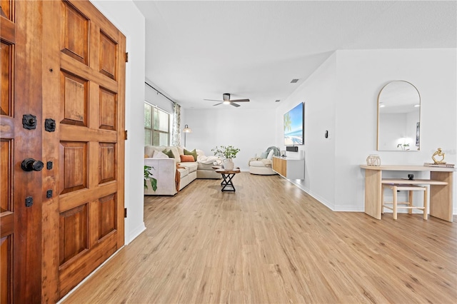 3041 Waterfall Dr, Spring Hill, FL 34608 - entryway with light wood-style floors, ceiling fan, and baseboards