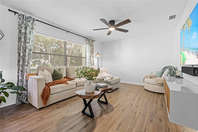 3041 Waterfall Dr, Spring Hill, FL 34608 - living area with a ceiling fan, light wood finished floors, and baseboards