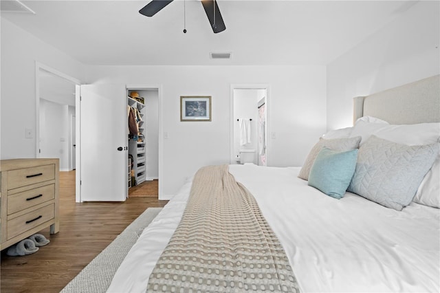 3041 Waterfall Dr, Spring Hill, FL 34608 - bedroom with wood finished floors, a walk in closet, ensuite bath, a closet, and ceiling fan