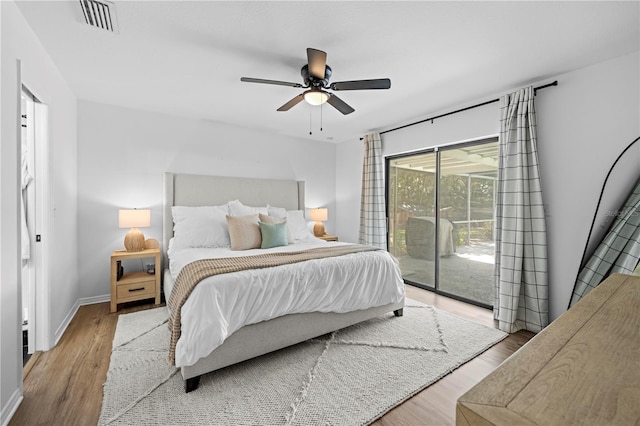 3041 Waterfall Dr, Spring Hill, FL 34608 - bedroom featuring access to exterior, wood finished floors, baseboards, and a ceiling fan