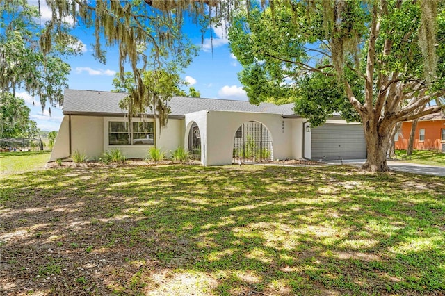 3041 Waterfall Dr, Spring Hill, FL 34608 - view of front of home featuring stucco siding, a front yard, and an attached garage