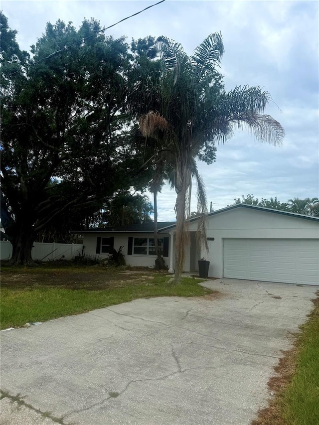4824 Huntington St NE, Saint Petersburg, FL 33703 - single story home featuring concrete driveway, stucco siding, an attached garage, and fence