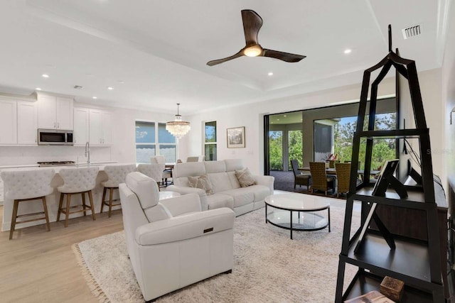 5410 Morey Farms Loop, Palmetto, FL 34221 - living room with plenty of natural light, light wood-style flooring, recessed lighting, a chandelier, and a ceiling fan