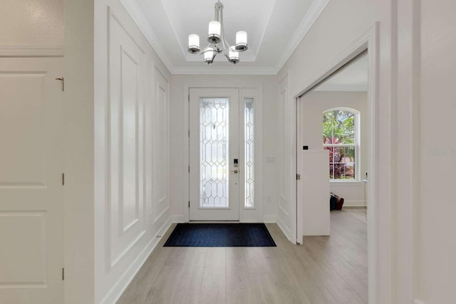5410 Morey Farms Loop, Palmetto, FL 34221 - foyer entrance featuring a chandelier, light wood-style floors, and crown molding