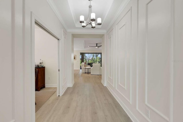 5410 Morey Farms Loop, Palmetto, FL 34221 - hall with a chandelier, light wood finished floors, ornamental molding, and baseboards