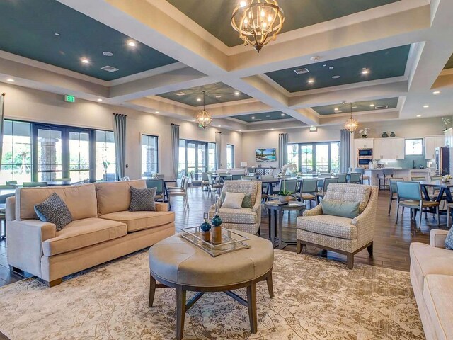 5410 Morey Farms Loop, Palmetto, FL 34221 - living room featuring a chandelier, coffered ceiling, beamed ceiling, and wood finished floors