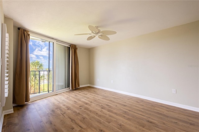 2530 Gary Cir Unit 301, Dunedin, FL 34698 - unfurnished room featuring wood finished floors, baseboards, and a ceiling fan
