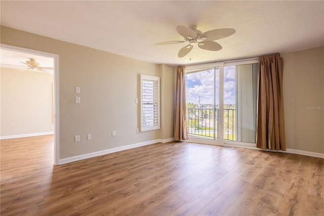 2530 Gary Cir Unit 301, Dunedin, FL 34698 - unfurnished room with wood finished floors, ceiling fan, and baseboards
