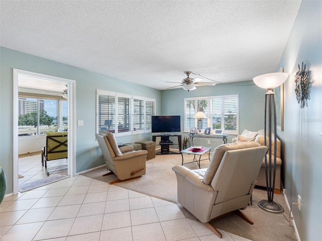 4700 Cove Cir Unit 301, Saint Petersburg, FL 33708 - living room with a textured ceiling, ceiling fan, baseboards, and light tile patterned floors