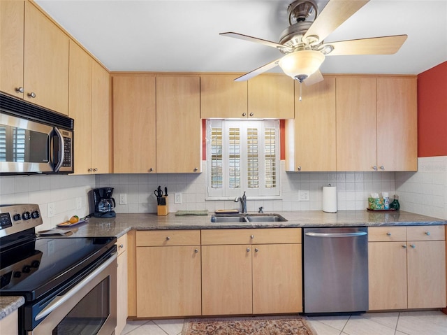 4700 Cove Cir Unit 301, Saint Petersburg, FL 33708 - kitchen with stainless steel appliances, a sink, light brown cabinets, tasteful backsplash, and ceiling fan