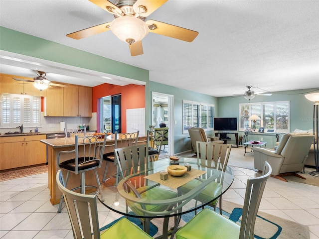 4700 Cove Cir Unit 301, Saint Petersburg, FL 33708 - dining area with a ceiling fan, light tile patterned flooring, and healthy amount of natural light