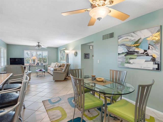 4700 Cove Cir Unit 301, Saint Petersburg, FL 33708 - dining room with a ceiling fan and light tile patterned flooring