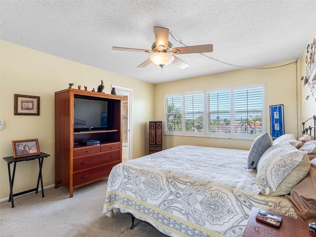 4700 Cove Cir Unit 301, Saint Petersburg, FL 33708 - bedroom featuring carpet, a textured ceiling, baseboards, and a ceiling fan
