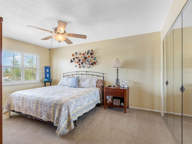 4700 Cove Cir Unit 301, Saint Petersburg, FL 33708 - bedroom with carpet, a closet, ceiling fan, a textured ceiling, and baseboards