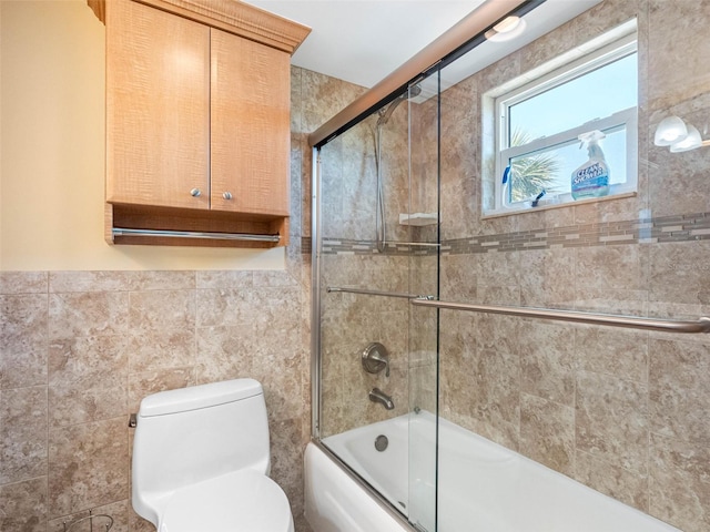 4700 Cove Cir Unit 301, Saint Petersburg, FL 33708 - full bath with tile walls, shower / bath combination with glass door, and toilet