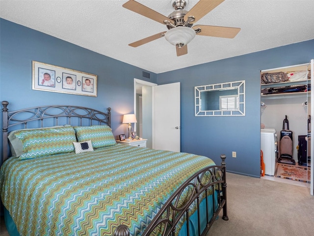 4700 Cove Cir Unit 301, Saint Petersburg, FL 33708 - carpeted bedroom with washer / dryer, a textured ceiling, and a ceiling fan