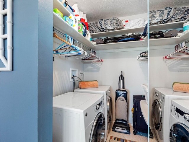 4700 Cove Cir Unit 301, Saint Petersburg, FL 33708 - washroom featuring washing machine and clothes dryer and light tile patterned floors