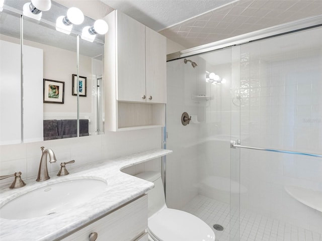 4700 Cove Cir Unit 301, Saint Petersburg, FL 33708 - bathroom featuring a stall shower, vanity, toilet, and decorative backsplash