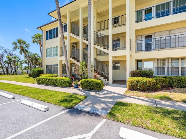 4700 Cove Cir Unit 301, Saint Petersburg, FL 33708 - view of apartment building / complex featuring uncovered parking and stairway