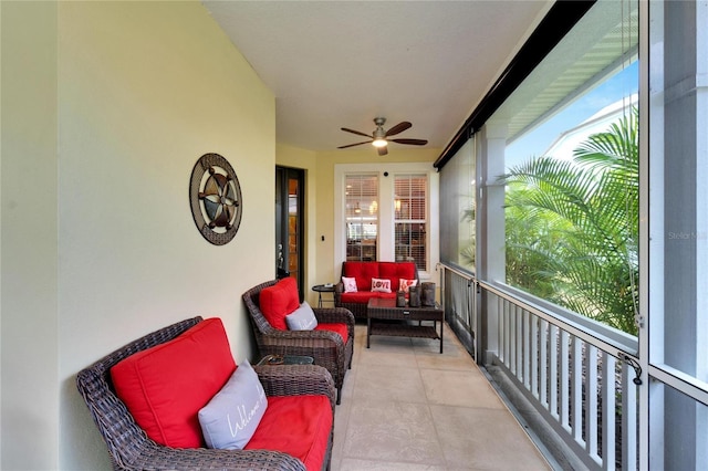 sunroom / solarium featuring a ceiling fan and an outdoor living space