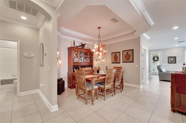 dining space with light tile patterned floors, arched walkways, crown molding, baseboards, and recessed lighting