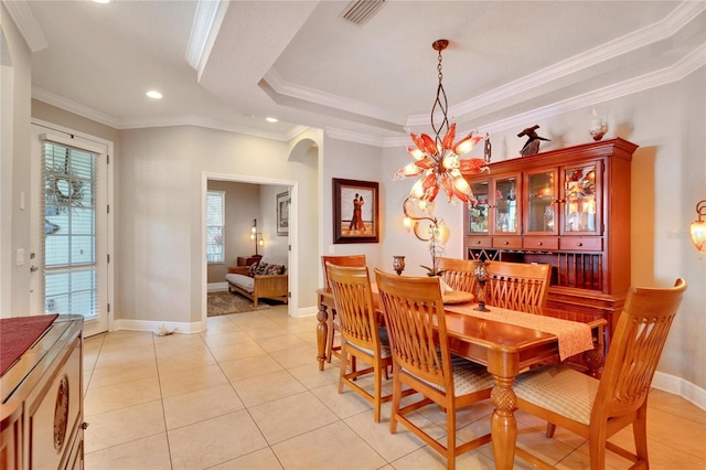 dining room featuring healthy amount of natural light, arched walkways, crown molding, recessed lighting, and light tile patterned floors