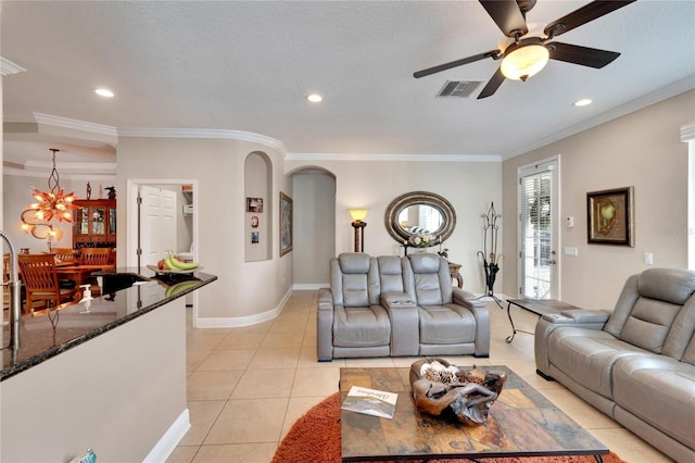 living room with ceiling fan, light tile patterned flooring, ornamental molding, arched walkways, and recessed lighting