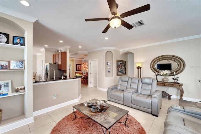 living room featuring arched walkways, ornamental molding, a ceiling fan, light tile patterned floors, and recessed lighting
