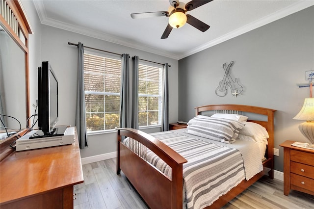 bedroom featuring light wood-style floors, crown molding, baseboards, and a ceiling fan