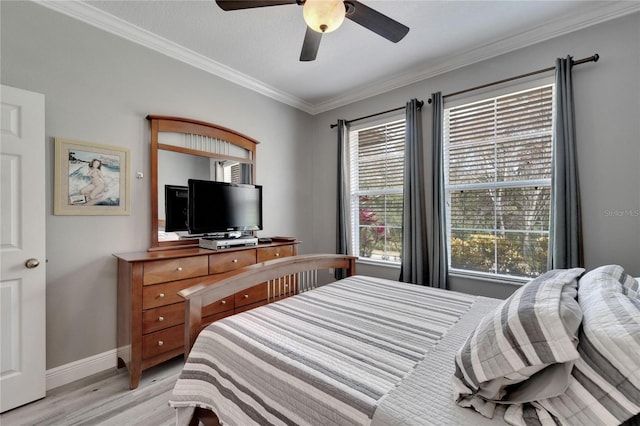 bedroom featuring light wood-style flooring, ornamental molding, baseboards, and a ceiling fan