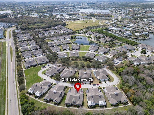 aerial view of property's location with nearby suburban area and a nearby body of water