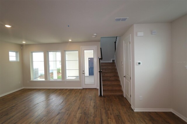 foyer with baseboards, dark wood finished floors, stairs, and recessed lighting