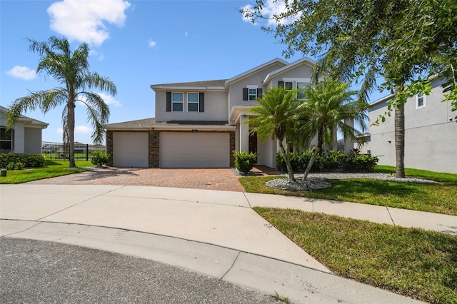 4950 Chase Ct, Saint Cloud, FL 34772 - traditional-style house featuring stucco siding, decorative driveway, a garage, and a front lawn