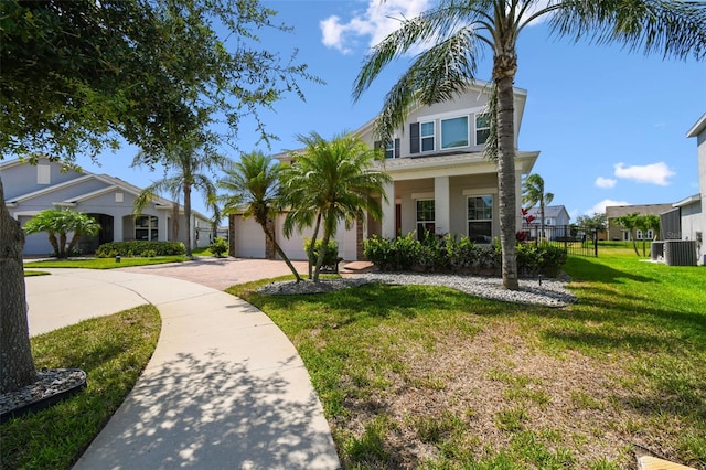 4950 Chase Ct, Saint Cloud, FL 34772 - view of front of property featuring a front lawn, cooling unit, driveway, stucco siding, and a garage