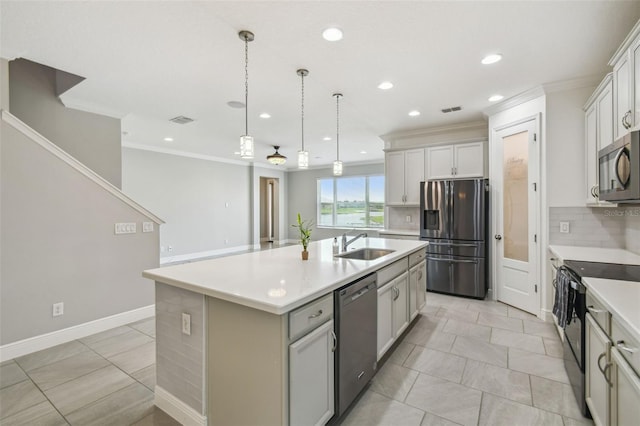4950 Chase Ct, Saint Cloud, FL 34772 - kitchen featuring stainless steel appliances, a sink, ornamental molding, recessed lighting, and a kitchen island with sink