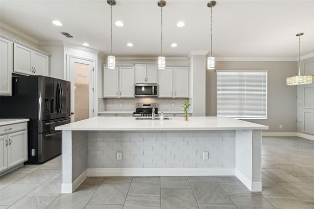 4950 Chase Ct, Saint Cloud, FL 34772 - kitchen with appliances with stainless steel finishes, a sink, decorative backsplash, light countertops, and an island with sink