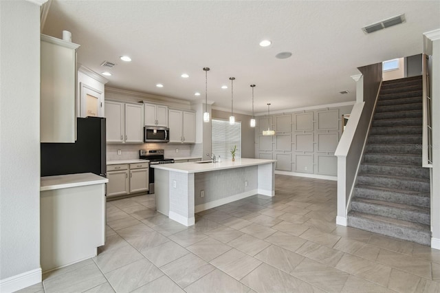4950 Chase Ct, Saint Cloud, FL 34772 - kitchen featuring stainless steel appliances, light countertops, a kitchen island with sink, a sink, and recessed lighting