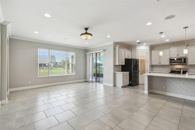 4950 Chase Ct, Saint Cloud, FL 34772 - kitchen featuring appliances with stainless steel finishes, crown molding, open floor plan, light countertops, and recessed lighting