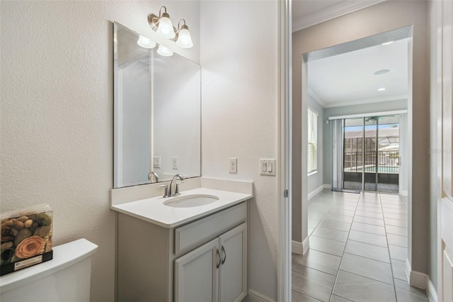 4950 Chase Ct, Saint Cloud, FL 34772 - bathroom featuring crown molding, toilet, vanity, tile patterned floors, and baseboards