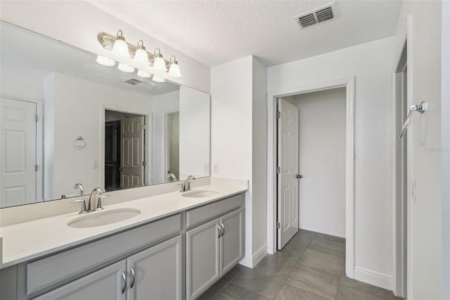 4950 Chase Ct, Saint Cloud, FL 34772 - full bathroom with double vanity and a textured ceiling